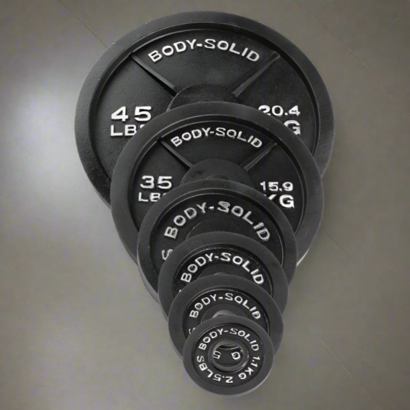 Body Solid Cast Iron Olympic Plates 45 lb, 35 lb, 25 lb, 10 lb, 5 lb, 2.5 lb inside Gym Floor