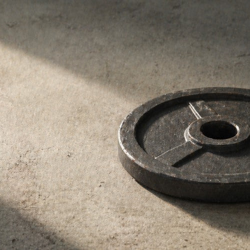 What Is a Cast Iron Weight Plate? Old-School Strength Explained - Dumbbells Direct Guide
