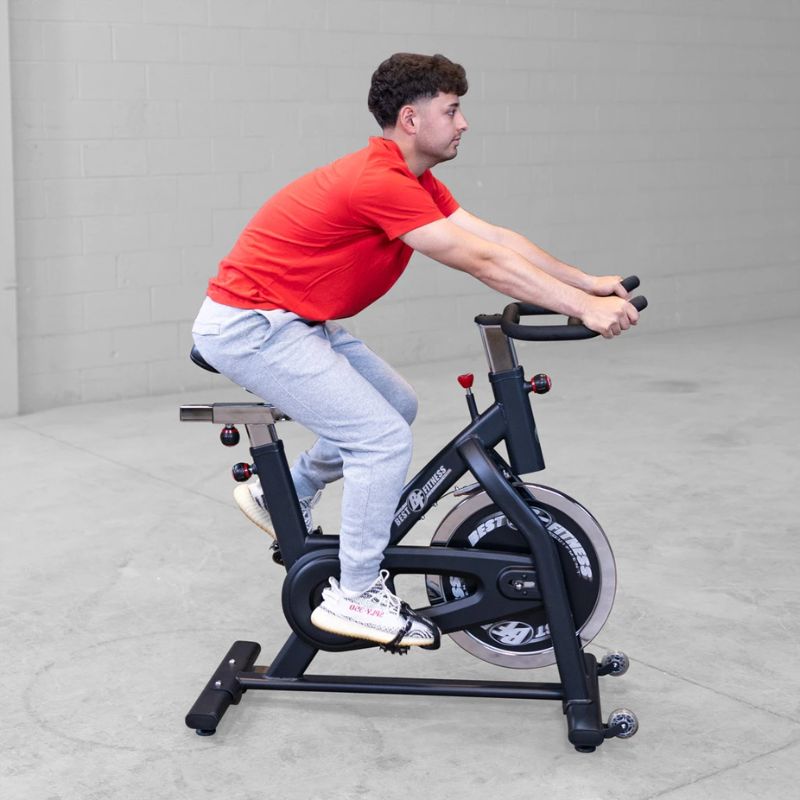 A man working out using Body Solid Best Fitness BFSB5B Indoor Training Cycle inside gym