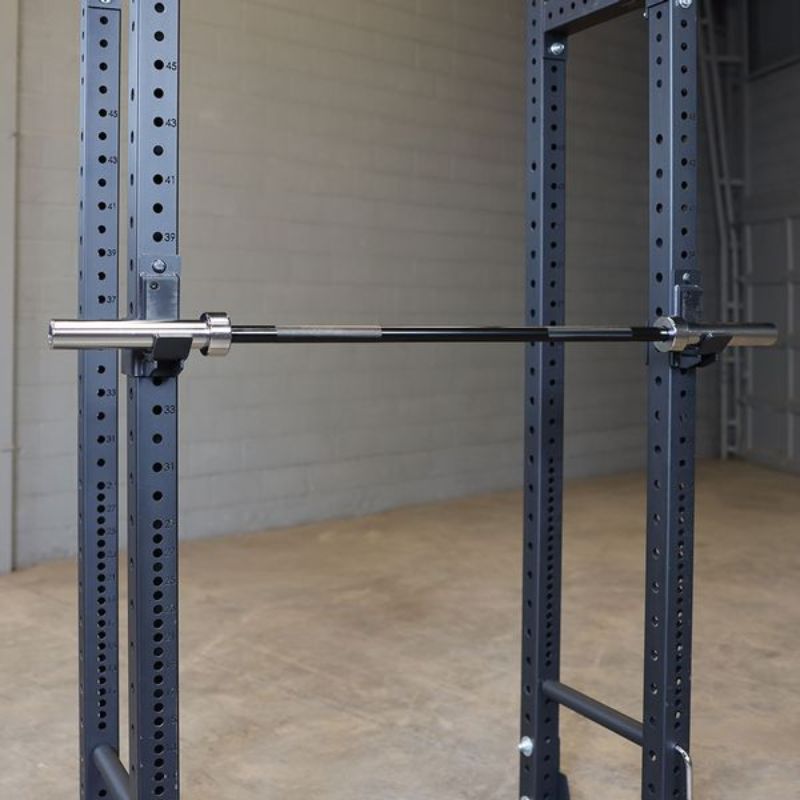 Body-Solid 6' Olympic Bar - Black In a Power Rack