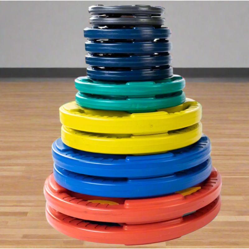 Body-Solid Color Rubber Grip Olympic Plates Stacked Set inside gym 