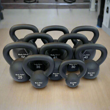 Body-Solid Iron Powder Coat Kettlebells 5-100 Pounds Set 5 lbs to 100 lbs inside Gym