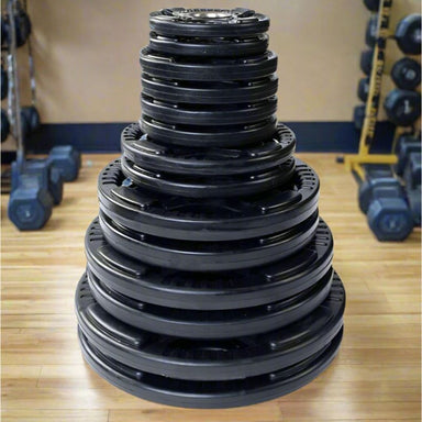 Body-Solid Rubber Grip Olympic Plates  Stacked Set inside Gym 