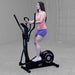 Body Solid Best Fitness Cross Trainer Elliptical - BFCT1B used by a female athlete side view (other side)