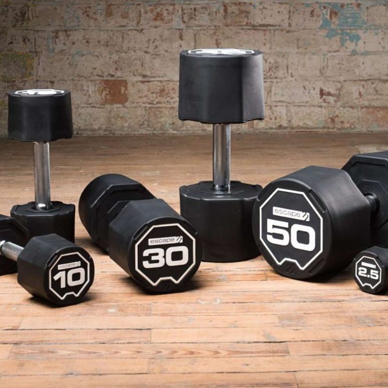 Escape Fitness Nucleus Rubber SBX Dumbbells on a Wooden Gym Floor