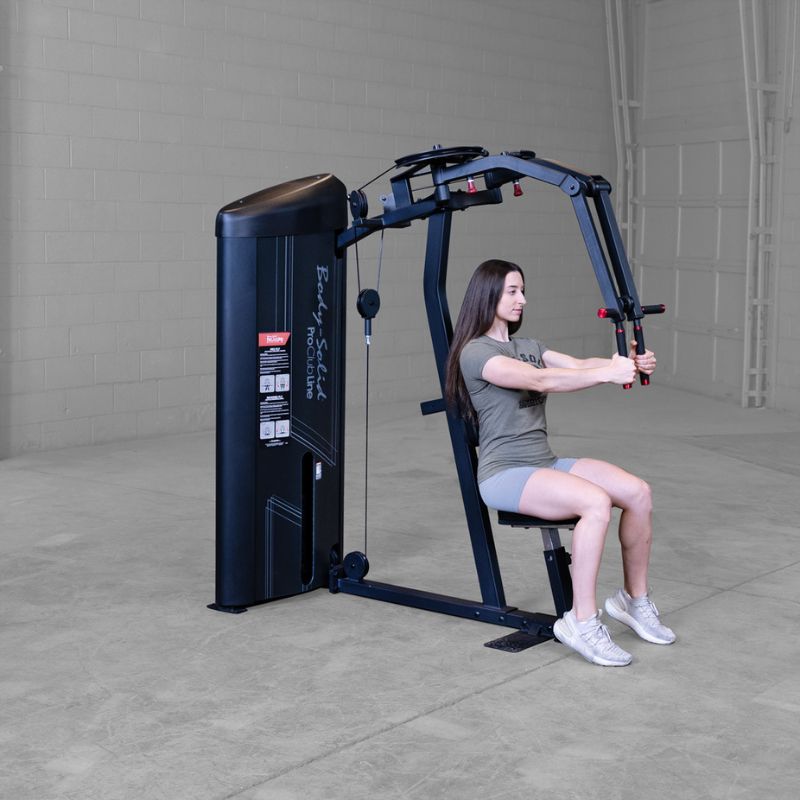 Female doing pec fly workout using Body-Solid Pro Clubline S2PECX Series 2 Pec Fly & Rear Delt