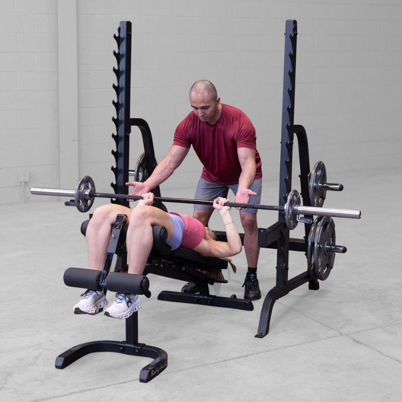 Female doing Decline Barbell Bench Press using Body-Solid GPR370B Olympic Multi Press Rack with Spotter