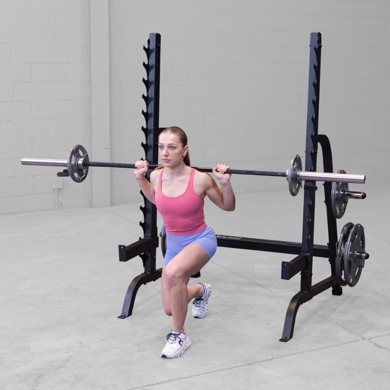 Female doing single leg barbell lunge using Body-Solid GPR370B Olympic Multi Press Rack