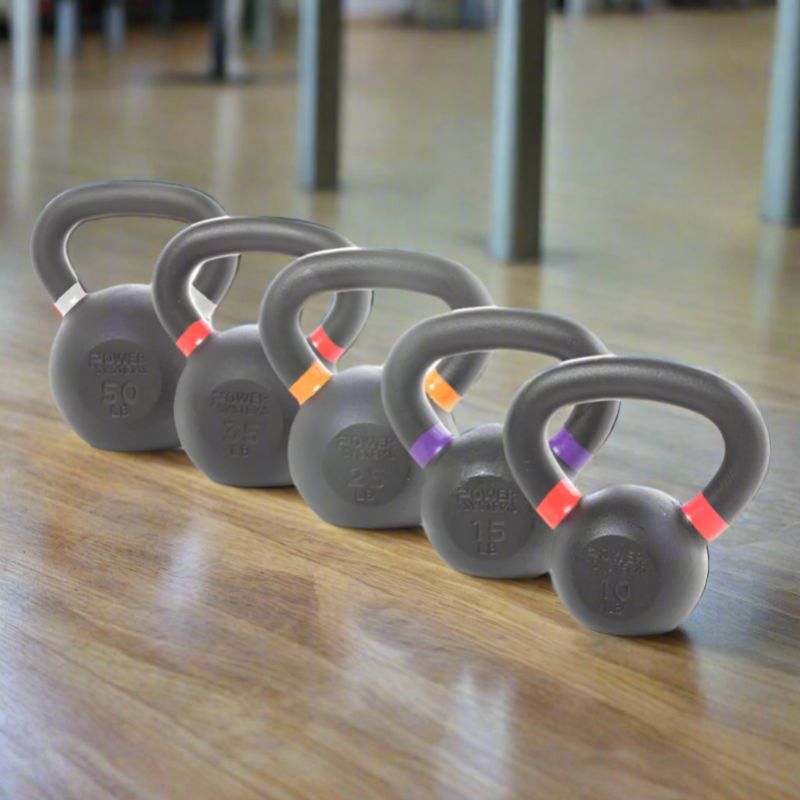 Power Systems Kettlebell Prime 50 lbs, 35 lbs, 25 lbs, 15 lbs, and 10 lbs inside Gym Floor