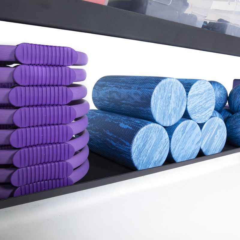 Power Systems Pilates Ring with Foam Rollers in a rack