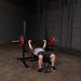 SFB125  Body Solid Pro Clubline Flat Utility Bench Sample Exercise with Barbell