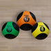 TAG Fitness Deluxe Medicine Ball - Rubber Medicine Ball 10lbs, 12 lbs, and 8lbs in gym floor