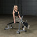 Body Solid Powerline Leg Curl Leg Extension Machine | PLCE165X - Sample Exercise with Plates